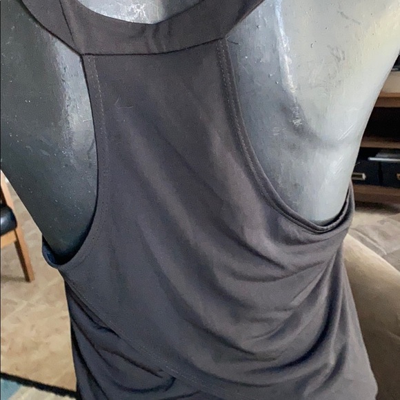 A black sleeveless top with a crossover design. - Picture 2 of 2